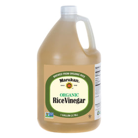 Marukan Organic Unseasoned Rice Vinegar bottle on a kitchen counter for versatile seasoning and light acidity