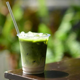 Hot cup of Matcha Kari with steam, showcasing smooth flavor.