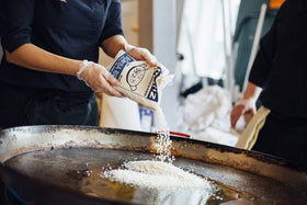 Matiz España Bomba rice cooking paella in a skillet, capturing aroma and texture