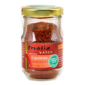 Matiz Espelette pepper bottle pour showing bright, mild heat for finishing dishes