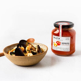 Matiz Sofrito ingredient overview with tomatoes, onion, garlic.