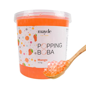 Mayde mango popping boba pearls in a tub add fruity flavor to bubble tea.