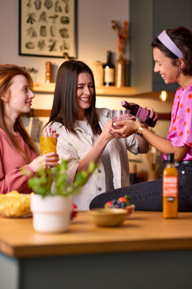 Mayer Mango Syrup bottle beside iced tea, showcasing refreshing mango infusion.