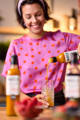 Mayer Mango Syrup atop yogurt parfait, adding natural fruit sweetness.