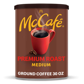 McCafé Premium Roast canister front with fresh ground coffee ready to brew.
