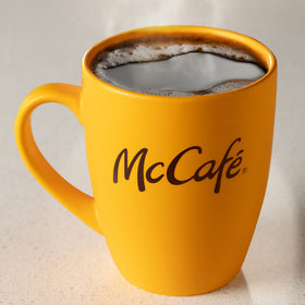 Warm kitchen scene with McCafé Premium Roast ready for morning ritual.