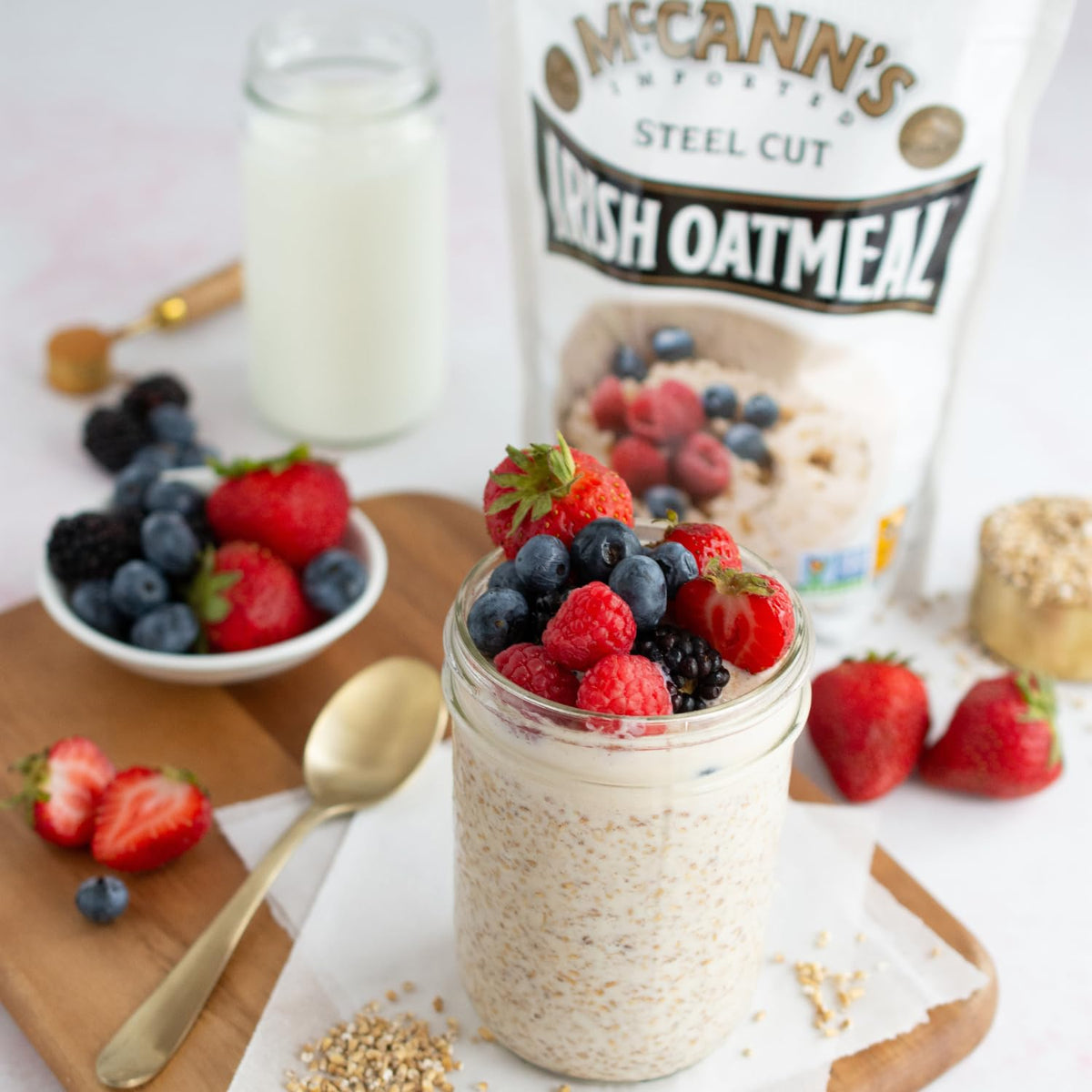 Serving bowl of warm McCann's porridge with toppings on a bright table