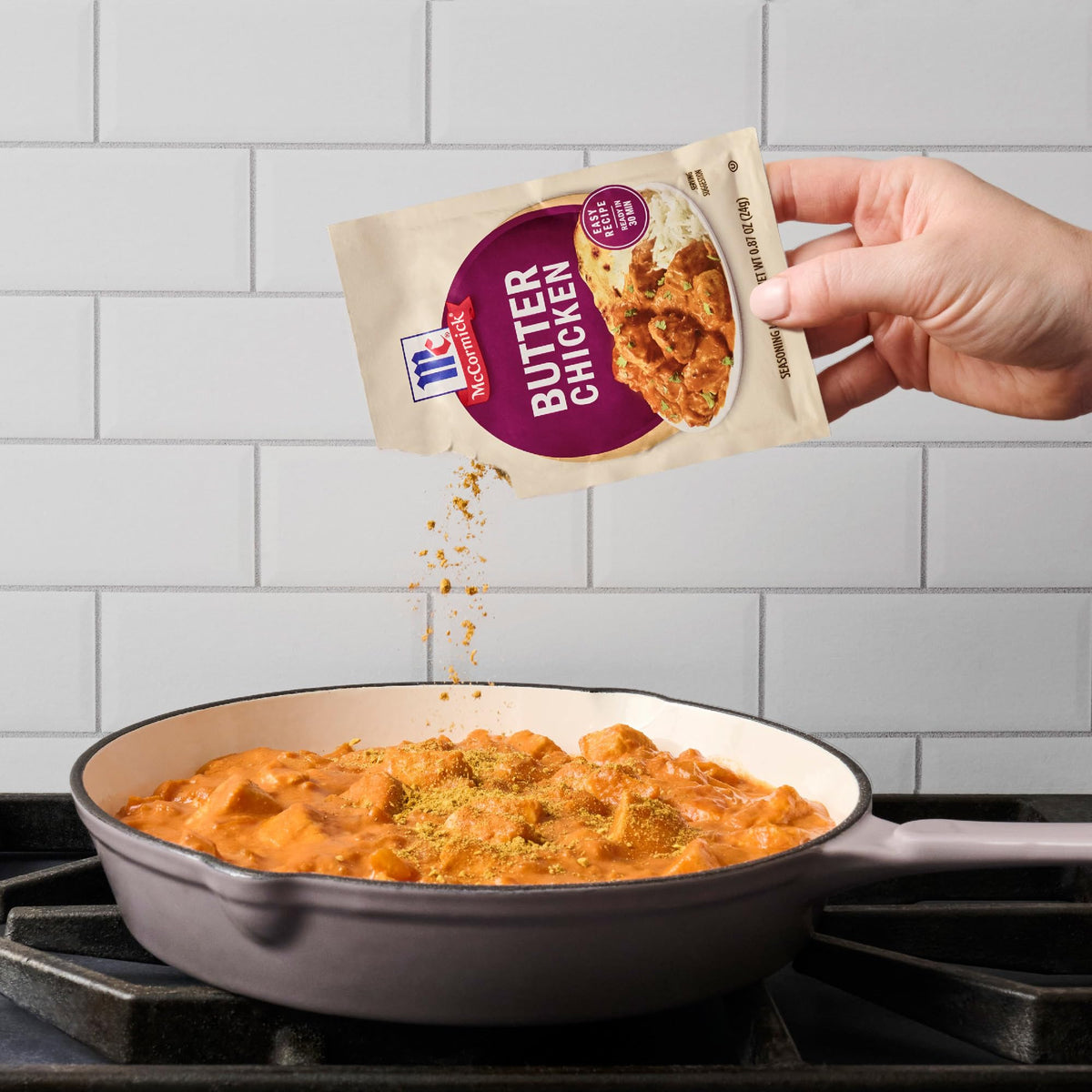 McCormick Butter Chicken stovetop-cooking in a simmering pan.
