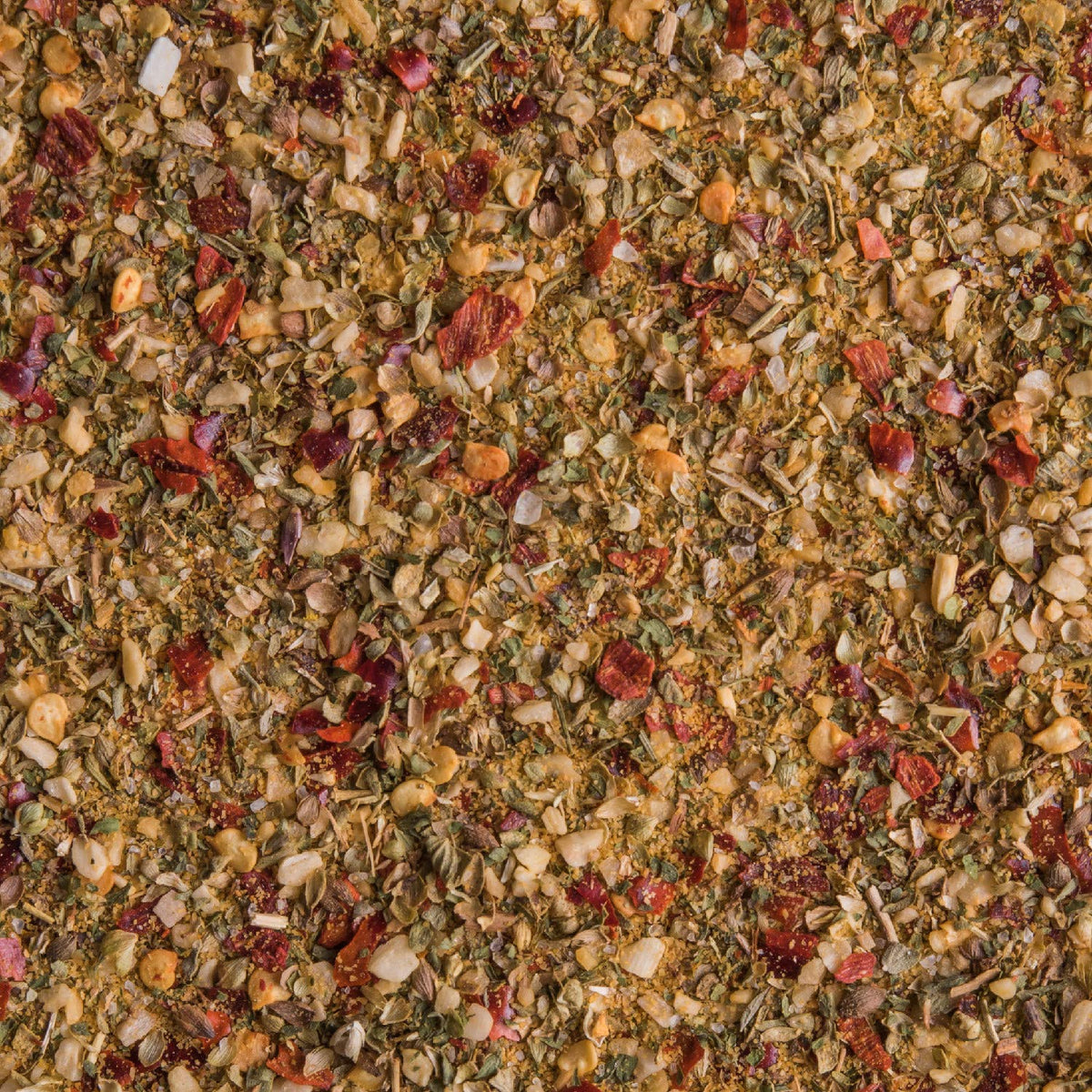 McCormick seasoning on vegetables and seafood at the stove.