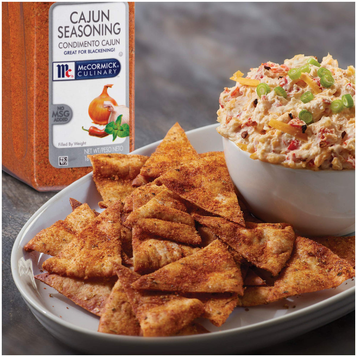 Seasoning dust on vegetables using McCormick Culinary Cajun spice for everyday flavor.