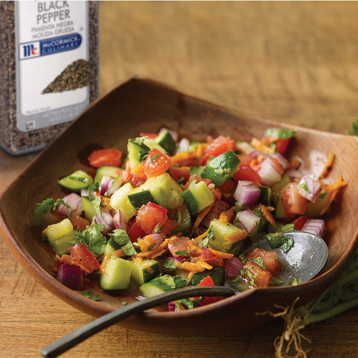 McCormick Culinary coarse grind black pepper sprinkled on vegetables for depth.