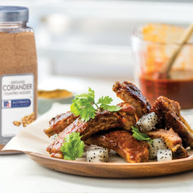 Ground coriander powder dusting over a dish brightens flavors.