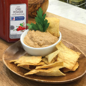 Ground spice close up shows earthy aroma and color of McCormick Culinary Light Chili Powder.
