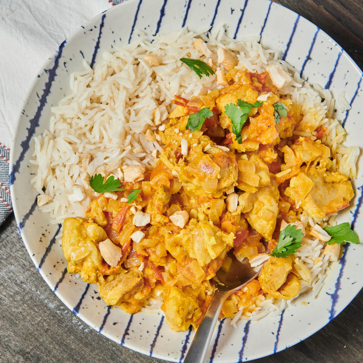 McCormick Curry Powder being poured, instantly elevates curries and chicken dishes.