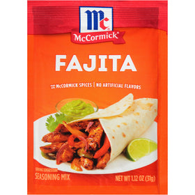 Sprinkling McCormick Fajita Seasoning Mix on sizzling steak for fajitas.