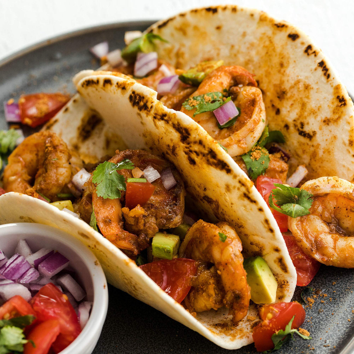 Sizzling pan releasing aroma of McCormick Gluten Free Taco Seasoning Mix.