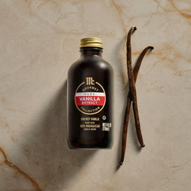 Glass jar of vanilla extract on a tidy kitchen counter