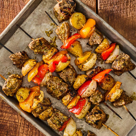 McCormick Grill Mates Brazilian Steakhouse Marinade on skewered steak and chicken for Brazilian vibes.