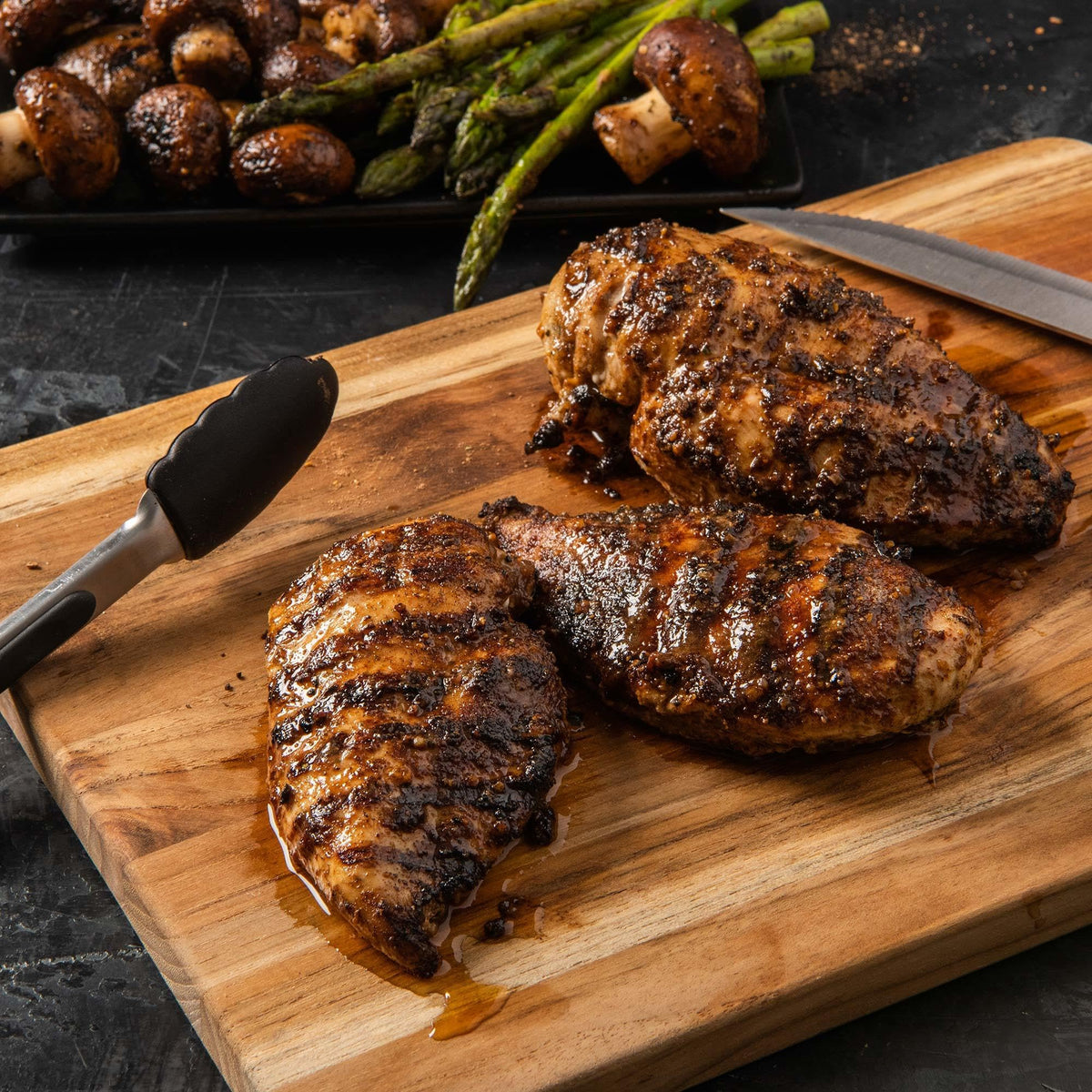 Chicken rubbed with parmesan and black garlic before grilling for a rich crust.