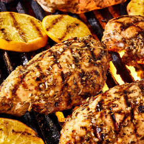 Family dinner setup with Griller's Choice marinade and grilled chicken