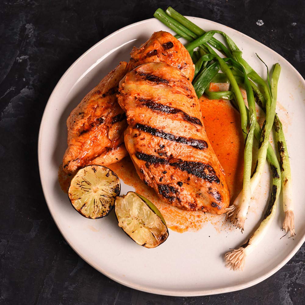 McCormick Grill Mates Honey Sriracha Marinade on a grill setup for easy marinating.