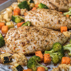 McCormick seasoning sprinkled on vegetables and chicken for balanced, tasty one-pan dinners.
