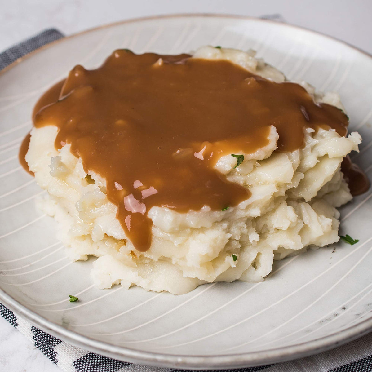 Gravy poured over mashed potatoes for creamy dinner