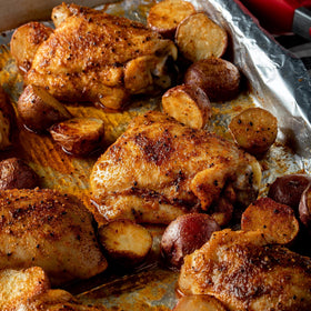 McCormick Perfect Pinch Rotisserie Chicken Seasoning used on raw chicken, delivers savory aroma.