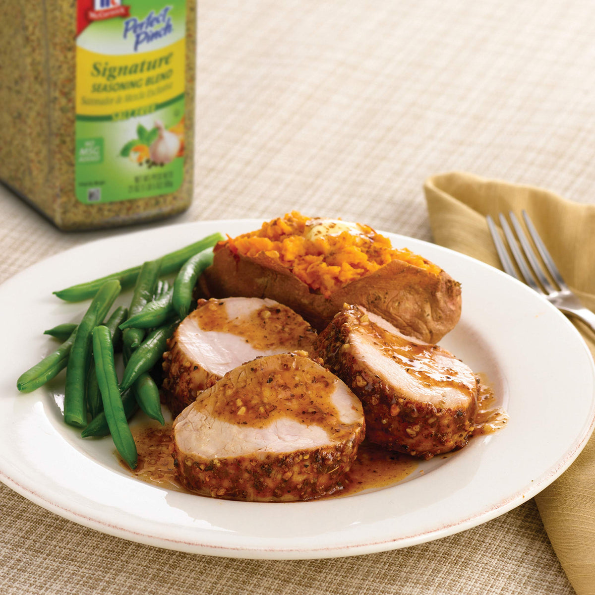 McCormick Perfect Pinch seasoning dusting over grilled meat for enhanced flavor