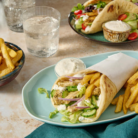 Pita wraps ready with McCormick gyro seasoning and fresh vegetables.