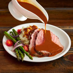 McCormick Poultry Gravy Mix plated serving pairs with potatoes and stuffing.