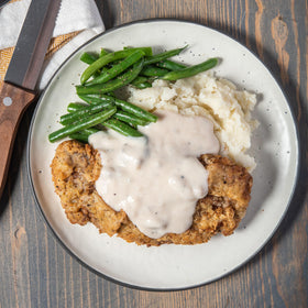 McCormick Gravy Mix served with chicken fried steak, savory home meal.
