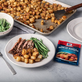Close-up of McCormick Toasted Onion & Garlic on potatoes enhancing flavor.