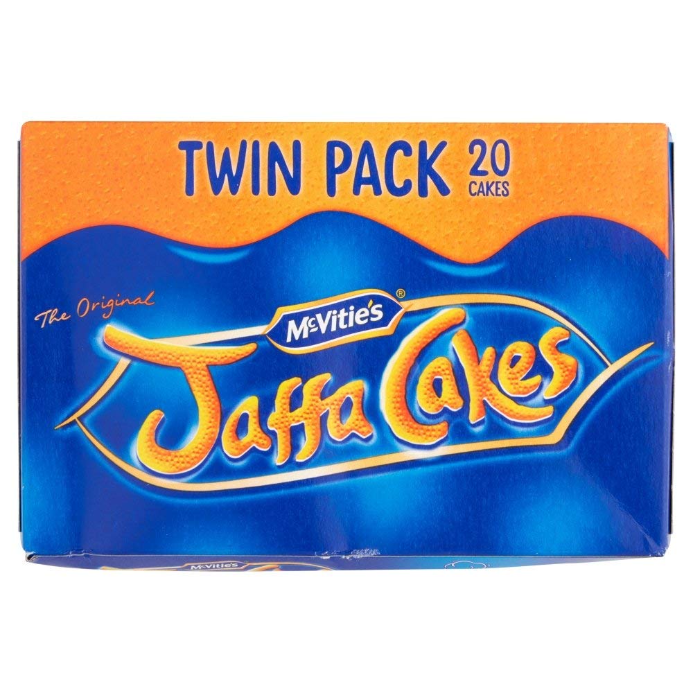 McVitie's Jaffa Cakes Twin Pack bite shot, showing chocolate top and orange center for a tasty snack.