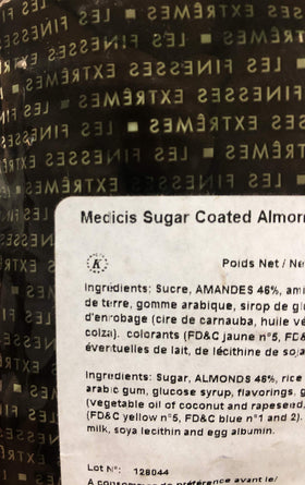 Medicis premium candied almonds close-up in a green bag, great for party favors.