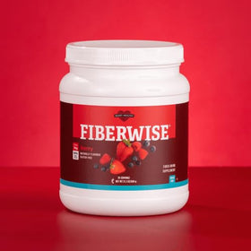 Glass of Melaleuca FiberWise Drink-Berry with fresh berries, ideal for on-the-go nutrition