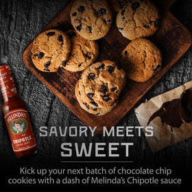 Close-up of Melinda's Chipotle Hot Sauce label and fresh ingredients.