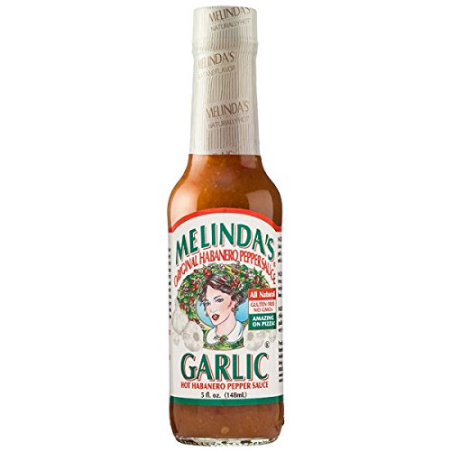 Melinda's Habanero Garlic Sauce 3-pack bottle pour enhances grilled dishes with bold heat.
