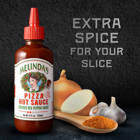 Melinda's Pizza Hot Sauce being poured to upgrade your slice with crisp heat.