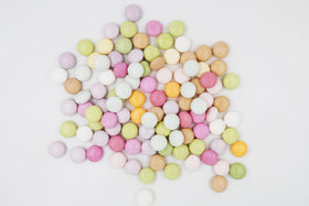Mentos Discovery candy on a table beside party invites and drinks.