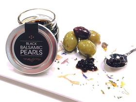 Messino Black Balsamic Pearls on spoon release vibrant flavors with each pop