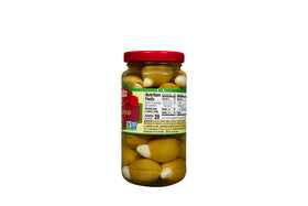 Mezzetta garlic stuffed olives beside grilled steak, adding a savory tang to your barbecue.