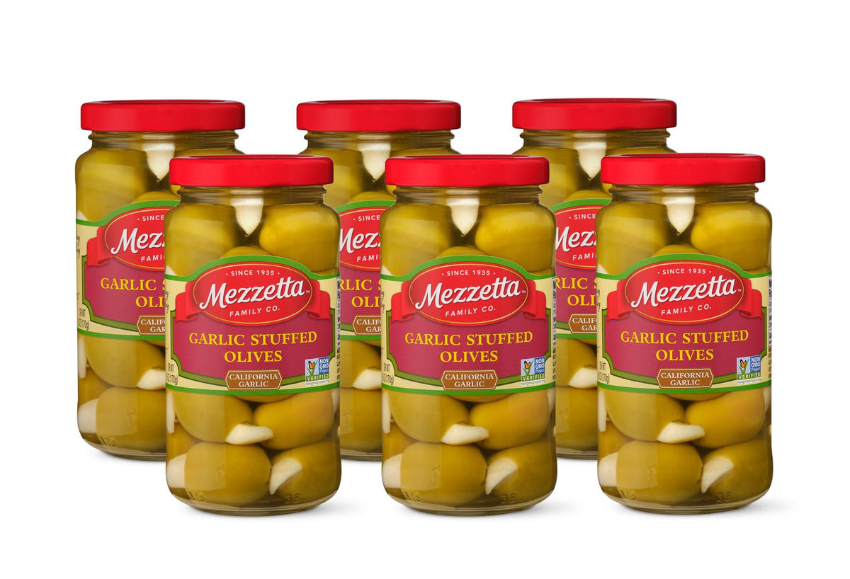 Mezzetta garlic stuffed olives in a glass jar, close-up, bold filling for savory appetizers.