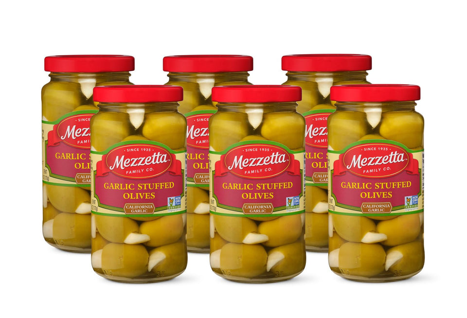 Mezzetta garlic stuffed olives in a glass jar, close-up, bold filling for savory appetizers.