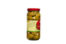 Mezzetta olives enhancing a grilled steak plate with garlic lift