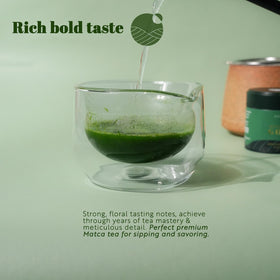 Shaded garden preparation with matcha being whisked in a bowl for ceremony-style tea