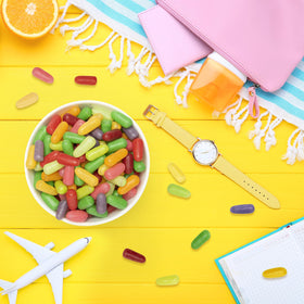 MIKE AND IKE Mega Mix Sour in a backpack, convenient snack for travel.
