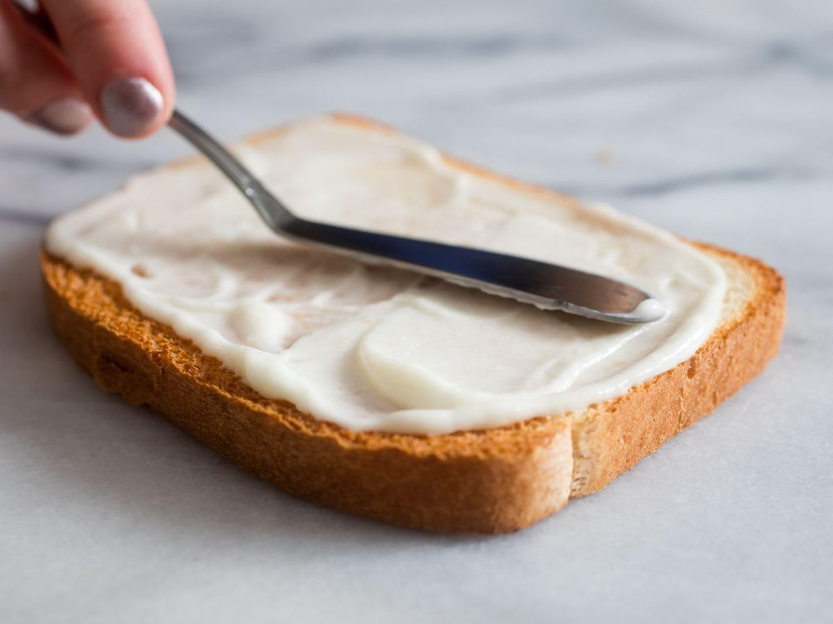Mike’s Amazing Real Mayonnaise bottle pour demonstrates smooth spread on bread