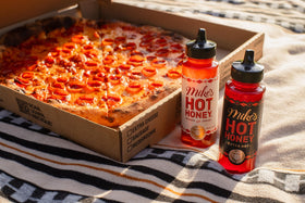 Close-up of chili peppers in Mike's Hot Honey for a bright kick.