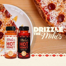 Mike's Hot Honey Extra Hot bottle pour highlighting intensified heat for bold dishes.